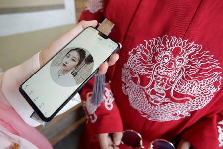 Lu Xiaowei shows a selfie taken while she was dressed in "Hanfu" in Beijing, China