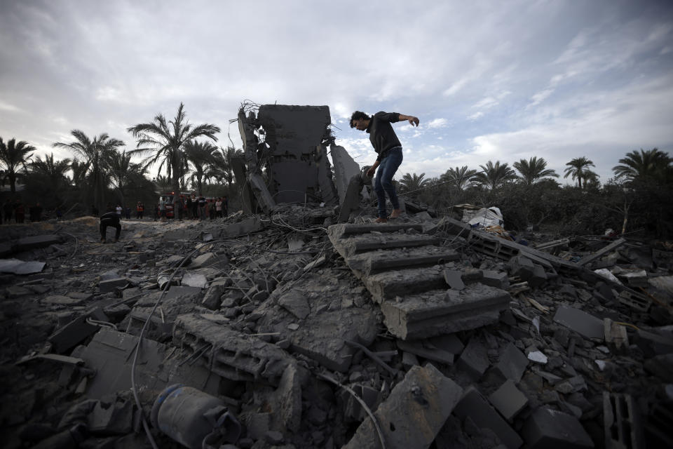 Palestinians inspect the damage of a destroyed house following Israeli airstrikes in the town of Khan Younis, southern Gaza Strip, Wednesday, Nov. 22, 2023. (AP Photo/Mohammed Dahman)