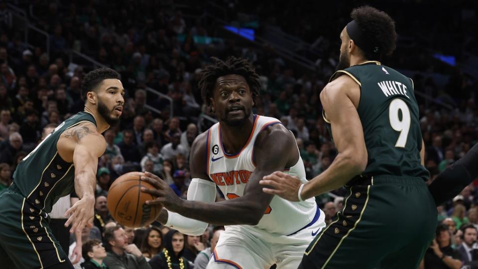 Mar 5, 2023; Boston, Massachusetts, USA; New York Knicks forward Julius Randle (30) looks for an opening between Boston Celtics guard Derrick White (9) and forward Jayson Tatum (0) during the first quarter at TD Garden.