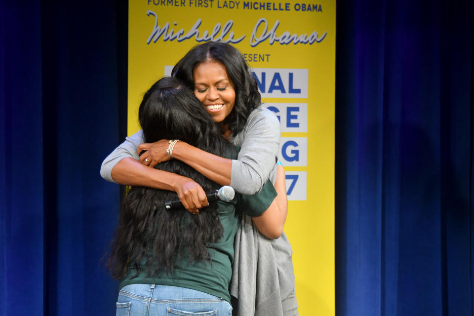 NEW YORK, NY - MAY 05:  Former First Lady Michelle Obama hugs a student onstage during MTV's 2017 College Signing Day With Michelle Obama at The Public Theater on May 5, 2017 in New York City.  (Photo by Mike Coppola/Getty Images for MTV)