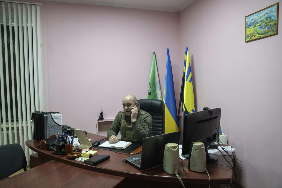 Vasyl Chynchyk, head of civil military administration of Toretsk, speaks via phone in Toretsk, eastern Ukraine, Monday, April 25, 2022. TToretsk residents have had no access to water for more than two months because of the war. (AP Photo/Evgeniy Maloletka)