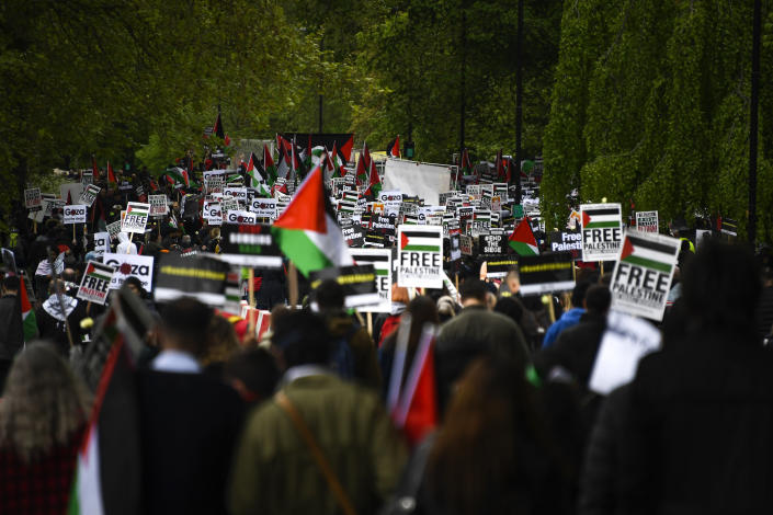 People hold placards and Palestinian flags as they march in solidarity with the Palestinian people amid the ongoing conflict with Israel, during a demonstration in London, Saturday, May 15, 2021. (AP Photo/Alberto Pezzali)