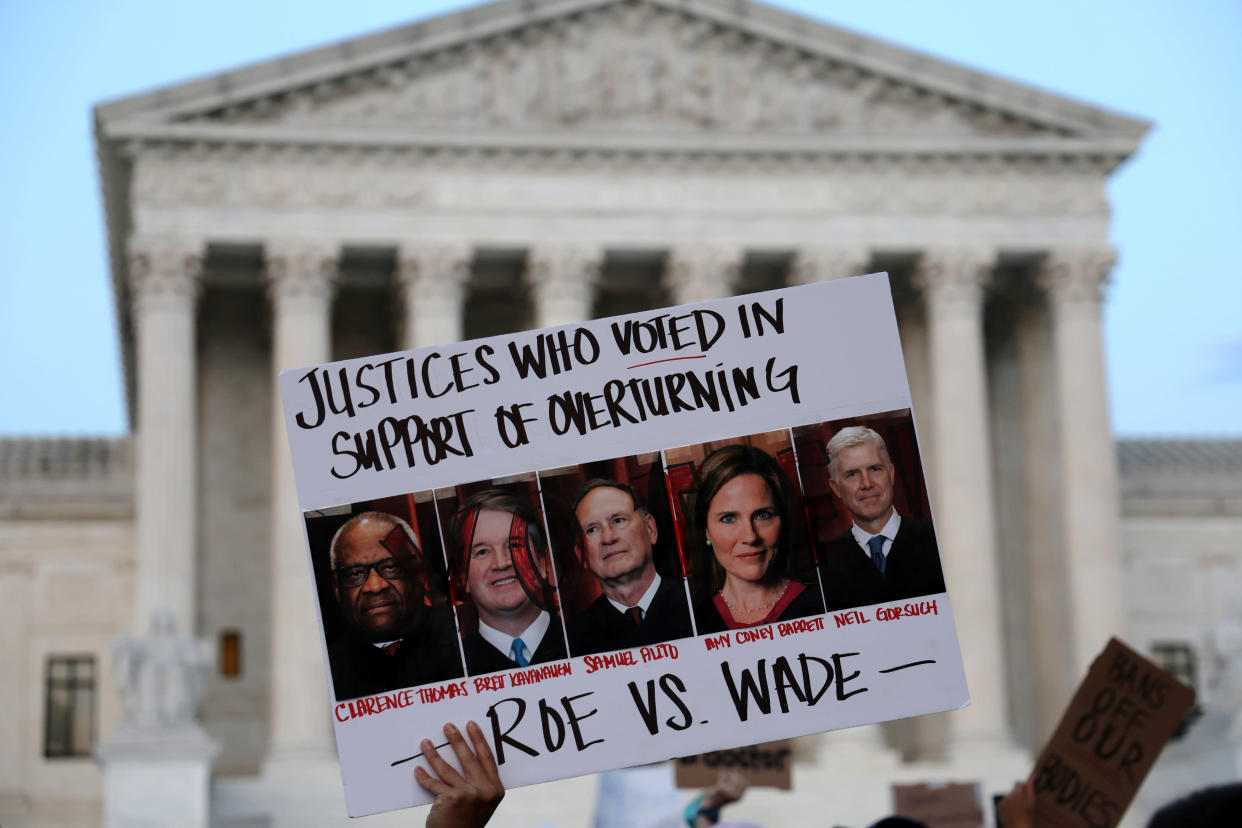 A pro-abortion-rights activist holds up a sign during a rally in front of the U.S. Supreme Court.