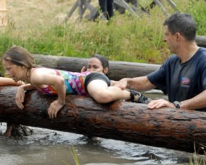 Child on NAVY obstacle course with dad