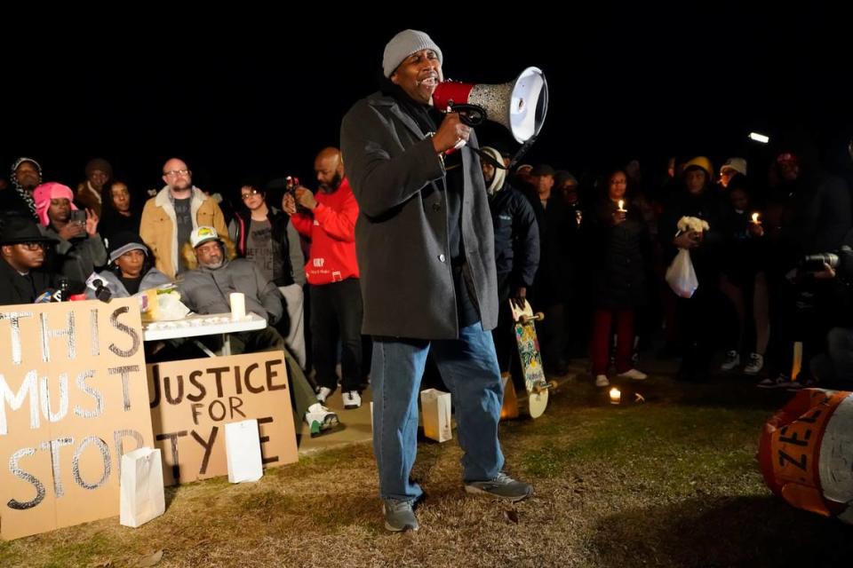 Rev. Andre E Johnson, of the Gifts of Life Ministries, preaches at a candlelight vigil for Tyre Nichols, who died after being beaten by Memphis police officers, in Memphis, Tenn., Thursday, Jan. 26, 2023. Behind at left are Tyre’s mother RowVaughn Wells and his stepfather Rodney Wells.