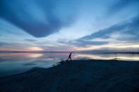 FILE PHOTO: A person walks along Bombay Beach