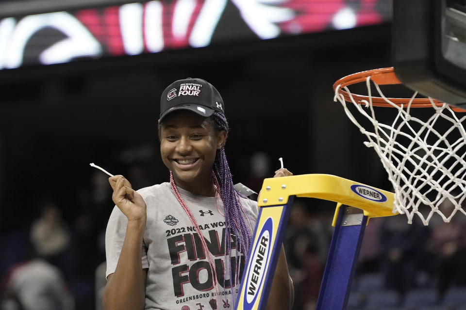 FILE - South Carolina forward Aliyah Boston (4) reacts after cutting the net following a college basketball game against Creighton in the Elite 8 round of the NCAA tournament in Greensboro, N.C., Sunday, March 27, 2022. Boston is a unanimous choice to the women's Associated Press preseason All-America team, Tuesday, Oct. 25, 2022. (AP Photo/Gerry Broome, File)