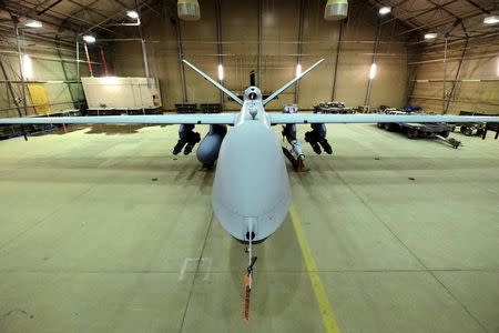 A U.S. Air Force MQ-9 Reaper drone sits armed with Hellfire missiles and a 500-pound bomb in a hanger at Kandahar Airfield, Afghanistan March 9, 2016. REUTERS/Josh Smith/Files