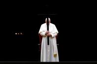 Pope Francis leads the Via Crucis (Way of the Cross) procession during Good Friday celebrations at the Vatican