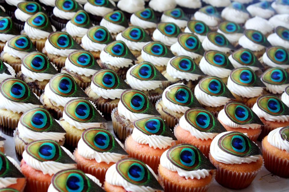 This photo provided by Cupcake Novelties shows peacock feather wedding cupcakes. The wedding favor, that little thank-you-for-coming gift, has risen to new heights with the bride and groom giving guests a wide range of favors that are meaningful to them. (AP Photo/Cupcake Novelties, Farozan Jivraj)