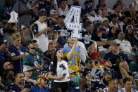 A fan holds up a sign that makes reference to Dallas Cowboys quarterback Dak Prescott (4) in the first half of an NFL football game against the Philadelphia Eagles in Arlington, Texas, Monday, Sept. 27, 2021. (AP Photo/Michael Ainsworth)