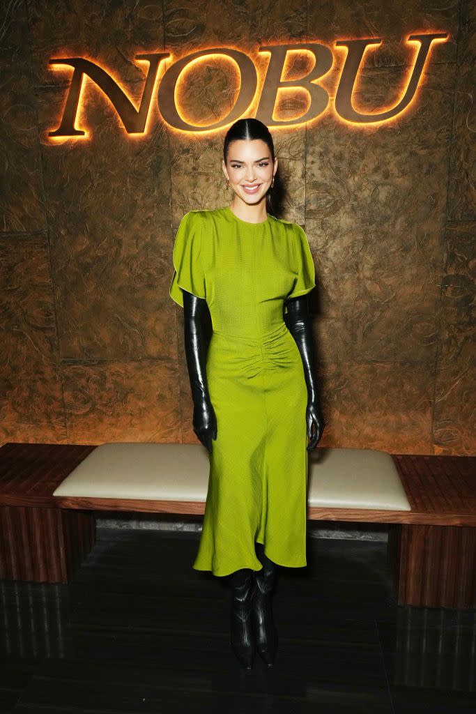 kendall jenner is glowing in green dress and latex gloves