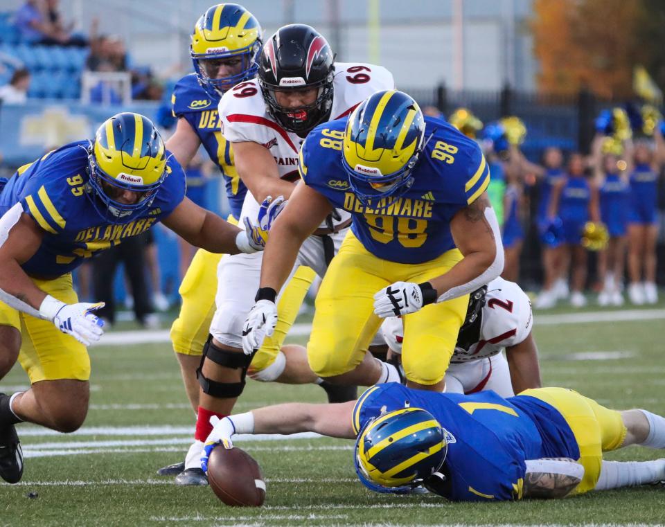 Delaware defensive back Ty Davis gets to a fumble before teammates Melkart Abou-Jaoude (95) and Nick Karika to set up a second quarter touchdown against St. Francis at Delaware Stadium, Saturday Sept. 16, 2023.