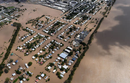 Houses are surrounded by floodwaters adjacent to the Fitzroy River (R) brought on by Cyclone Debbie in Rockhampton, Australia, April 6, 2017. AAP/Dan Peled/via REUTERS