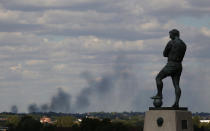 Smoke is seen over north London from a view behind the Bobby Moore statue outside Wembley Stadium as the England v Netherlands game is called off on Wednesday evening.