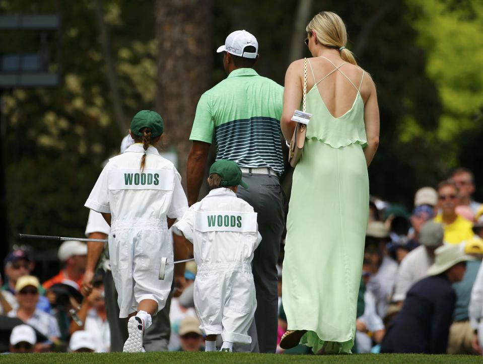 U.S. golfer Tiger Woods walks on the first green with girlfriend Lindsey Vonn and his two children Sam (L) and Charlie during the par 3 event held ahead of the 2015 Masters at Augusta National Golf Course in Augusta, Georgia April 8, 2015. REUTERS/Mark Blinch