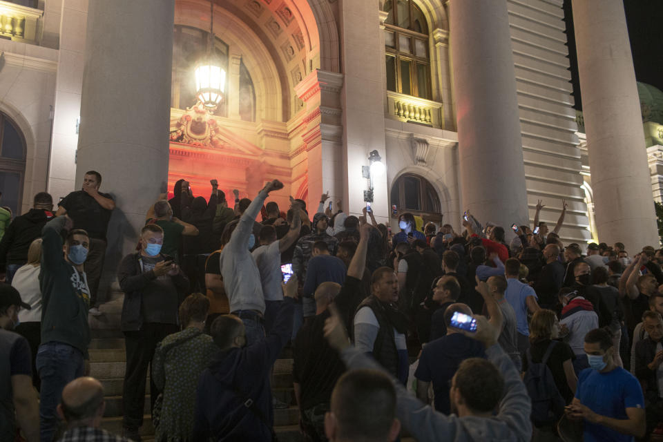 Protesters gather in front of the Serbian parliament in Belgrade, Serbia, Tuesday, July 7, 2020. Thousands of people protested the Serbian president's announcement that a lockdown will be reintroduced after the Balkan country reported its highest single-day death toll from the coronavirus Tuesday. (AP Photo/Marko Drobnjakovic)