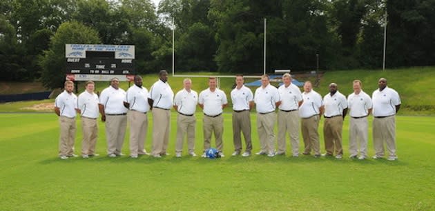 The Americus-Sumter coaching staff, with Michael Pollock at center — Americus-Sumter football