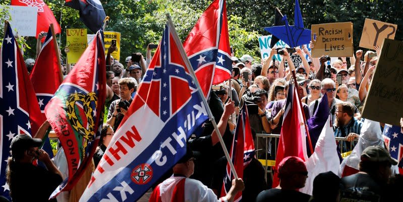 FILE PHOTO: Members of the Ku Klux Klan face counter-protesters as they rally in support of Confederate monuments in Charlottesville, Virginia, U.S. on July 8, 2017. REUTERS/Jonathan Ernst/File Photo