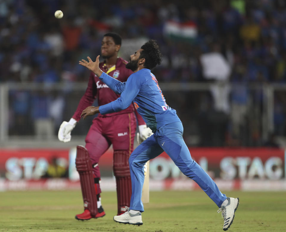 India's Ravindra Jadeja, right, runs to catch the ball after dismissing West Indies' Shimron Hetmyer, left, during the second Twenty20 international cricket match between India and West Indies in Thiruvanathapuram, India, Sunday, Dec. 8, 2019. (AP Photo/Aijaz Rahi)