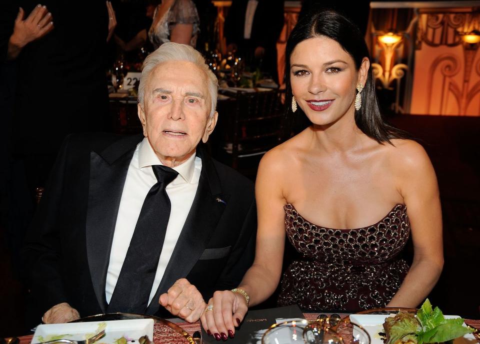 <p>Douglas with his daughter-in-law, actress Catherine Zeta-Jones, at an American Film Institute Lifetime Achievement Award event held in his honor. </p>