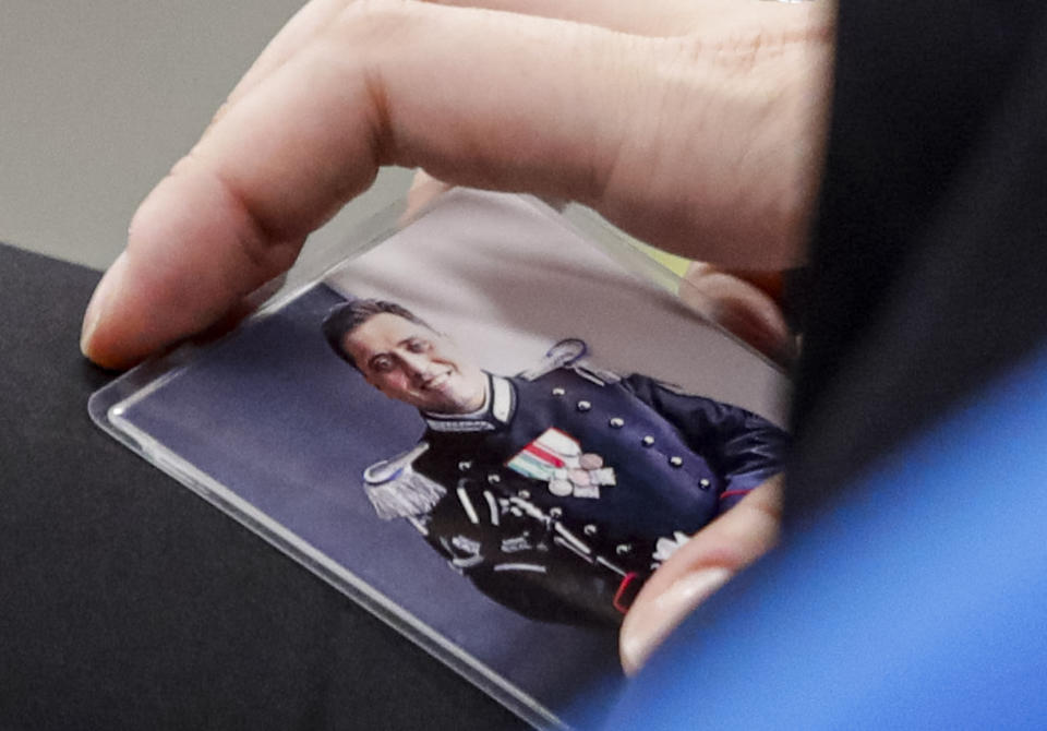 FILE -- In this Wednesday, Sept. 9, 2020 file photo, Rosa Maria Esilio, widow of Italian Carabinieri paramilitary police officer Mario Cerciello Rega, holds a photograph of her husband ahead of a hearing of the trial in which two American tourists are accused of his murder in Rome. Two American men face a new trial Friday, March 8, 2024, in the slaying of an Italian plainclothes police officer during a botched sting operation after Italy’s highest court threw out their convictions.(AP Photo/Alessandra Tarantino, Pool, file)