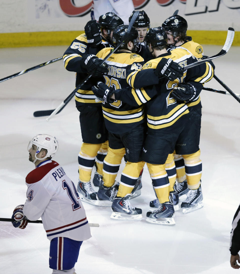 Boston Bruins center Carl Soderberg is surrounded by teammates after scoring against Montreal Canadiens goalie Carey Price during the first period of Game 5 in the second-round of the Stanley Cup hockey playoff series in Boston, Saturday, May 10, 2014. Canadiens center Tomas Plekanec (14) skates by. (AP Photo/Charles Krupa)
