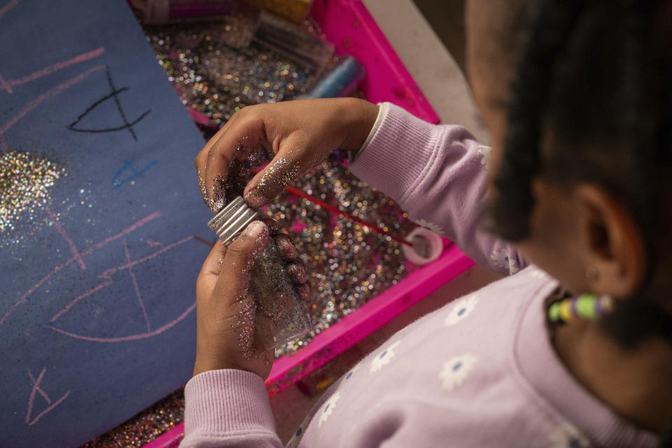 Neveah, 6, makes art at home in Oakland, Calif., on Friday Nov. 24, 2023. (AP Photo/Loren Elliott)