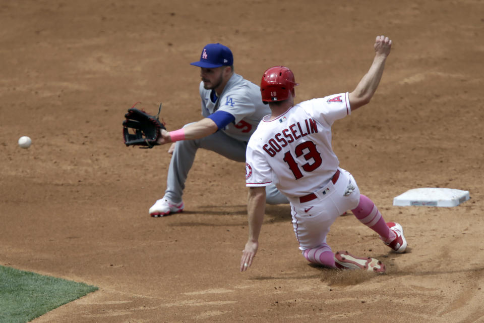 Los Angeles Dodgers second baseman Gavin Lux, left, waits for the throw before tagging out Los Angeles Angels' Phil Gosselin on a steal attempt during the third inning of a baseball game in Anaheim, Calif., Sunday, May 9, 2021. (AP Photo/Alex Gallardo)