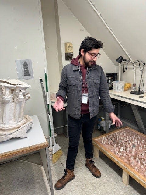 Pratt Munson artist-in-residence Felipe Lopez stands between two elements of a piece, called "Consagrado a la memoria" or "Dedicated to memory," that will be featured in his solo exhibition at the Pratt Munson gallery.