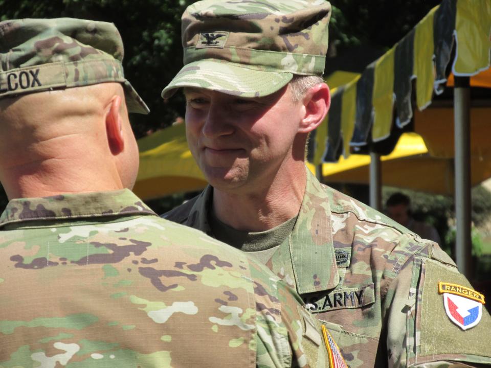 Col. Scott Pence, outgoing Fort Bragg garrison commander, shakes hands with incoming garrison commander Col. John Wilcox during a command change ceremony Friday, July 24, 2022, at Fort Bragg.