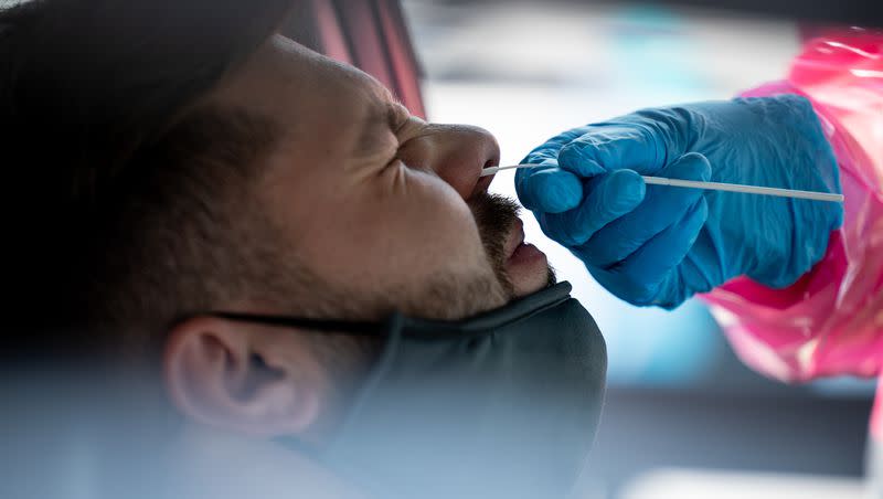 Tristan McGraw gets tested for COVID-19 at a NOMI Health drive-thru test site in West Valley City on June 10, 2022.