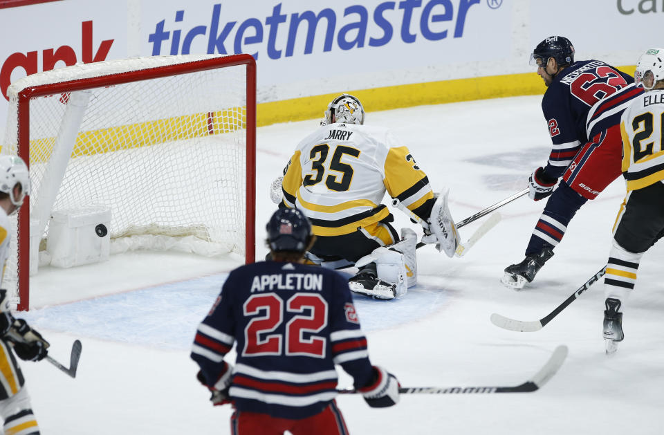 Winnipeg Jets' Nino Niederreiter (62) scores on Pittsburgh Penguins goaltender Tristan Jarry (35) during the first period of an NHL hockey game Saturday, Feb. 10, 2024, in Winnipeg, Manitoba. (John Woods/The Canadian Press via AP)