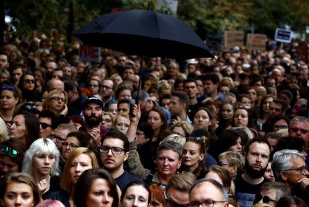 People gather as they take part in a "Black Protest" in front of the Parliament in Warsaw, Poland. Women and doctors could face prison if convicted of causing what the proposed rules call "death of a conceived child", and critics say doctors would be discouraged from doing prenatal testing, particularly if that carried the risk of miscarriage. REUTERS/Kacper Pempel