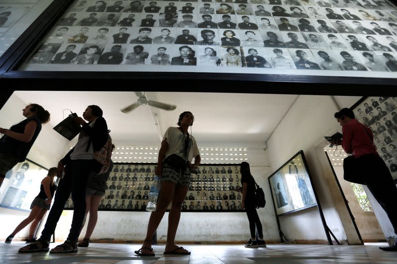 A visitor looks at pictures of victims of the Khmer Rouge regime at Tuol Sleng Genocide Museum in Phnom Penh