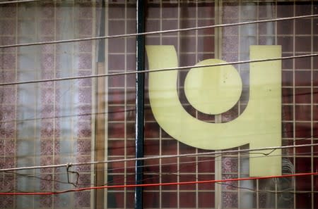 FILE PHOTO: The logo of Punjab National Bank (PNB) is seen on a branch office window in New Delhi