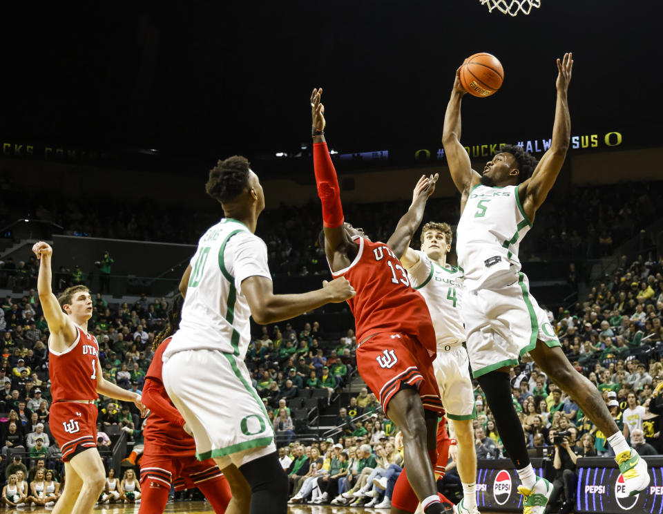 Oregon guard Jermaine Couisnard (5), grabs a rebound Utah during the second half of an NCAA college basketball game in Eugene, Ore., Saturday, March 9, 2024. Oregon beat Utah 66-65. (AP Photo/Thomas Boyd)