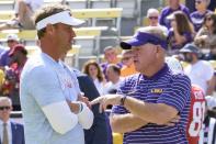Mississippi head coach Lane Kiffin, left, talks with LSU head coach Brian Kelly before an NCAA college football game in Baton Rouge, La., Saturday, Oct. 22, 2022. (AP Photo/Matthew Hinton)
