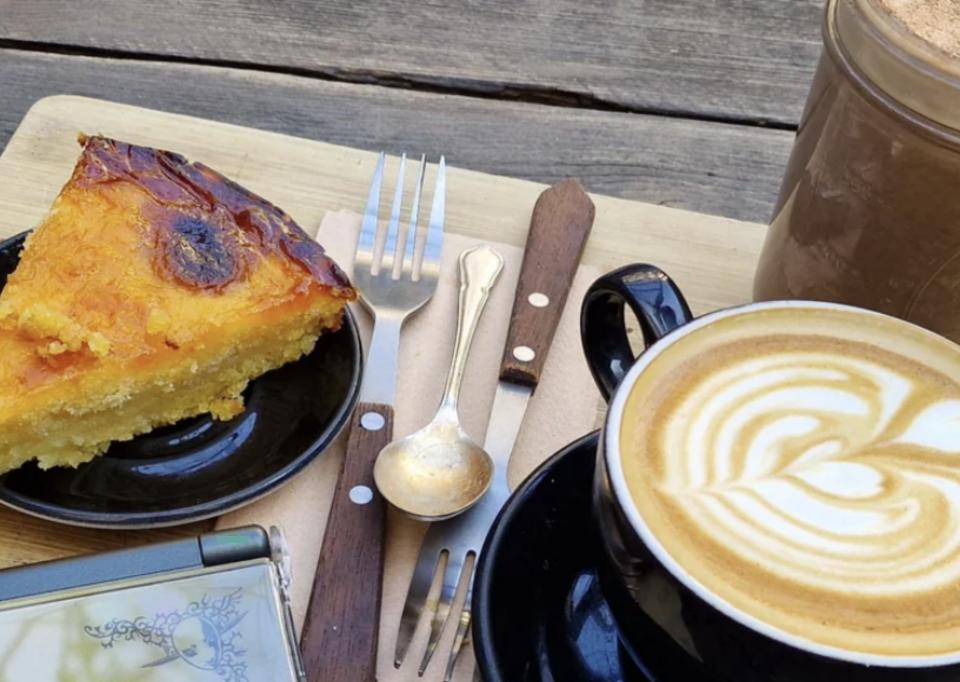 Someone enjoying coffee and a slice of savory cake