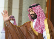 In this photo released by Saudi Royal Palace, Saudi Crown Prince Mohammed bin Salman, waves to French President Emmanuel Macron, upon his arrival in Jiddah, Saudi Arabia, Saturday, Dec. 4, 2021. (Bandar Aljaloud/Saudi Royal Palace via AP)