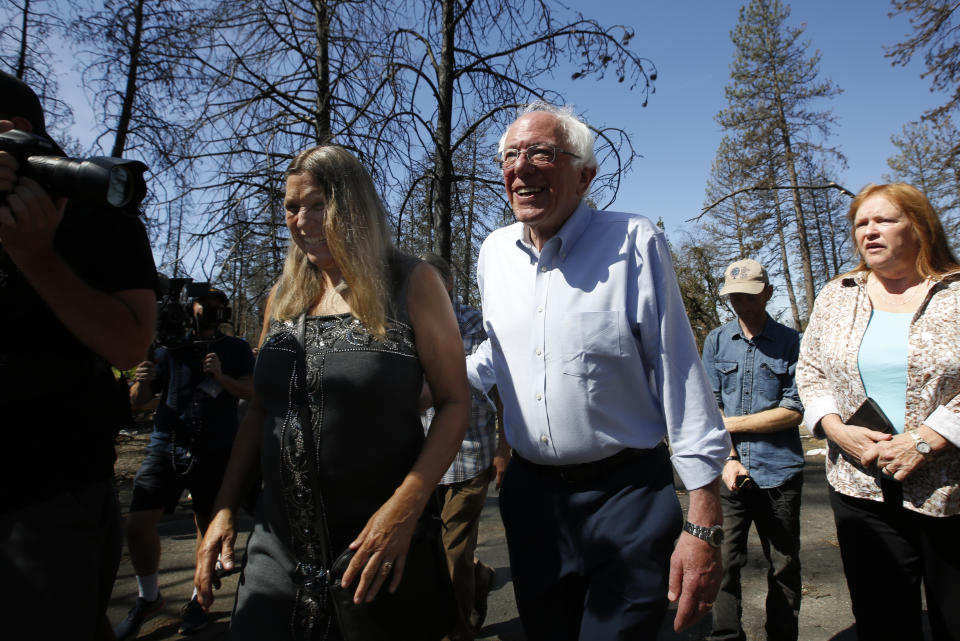 Democratic presidential candidate Sen. Bernie Sanders, I-Vermont, right, talks with area resident Susan Dobra, left, as he tours a mobile home park that was destroyed by last year's wildfire in Paradise, Calif., Thursday, Aug. 22, 2019. Sanders released a $16.3 trillion climate plan Thursday that builds on the Green New Deal and calls for the United States to move to renewable energy across the economy by 2050 and declare climate change a national emergency. (AP Photo/Rich Pedroncelli)