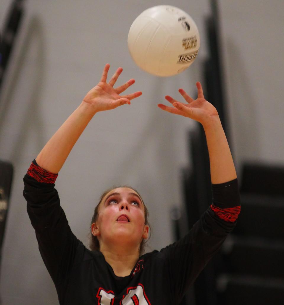 Claire Kavoulis, junior on Oliver Ames volleyball team, sets up the ball for a teammate to strike in their game against Stoughton on Monday, Sept. 12, 2022.