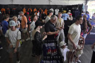 Race fans buy merchandise at a shop at the Formula One Miami Grand Prix auto race at Miami International Autodrome, Sunday, May 8, 2022, in Miami Gardens, Fla. (AP Photo/Wilfredo Lee)