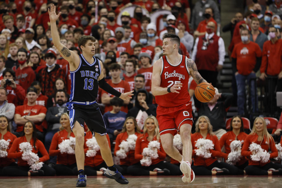 Ohio State's Kyle Young, right, looks for an open pass as Duke's Joey Baker defends during the first half of an NCAA college basketball game Tuesday, Nov. 30, 2021, in Columbus, Ohio. (AP Photo/Jay LaPrete)