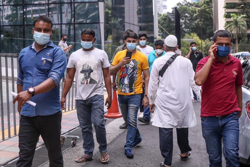 Foreign workers are seen at the KLCC vaccination centre to receive their Covid-19 jab July 27, 2021. — Picture by Ahmad Zamzahuri