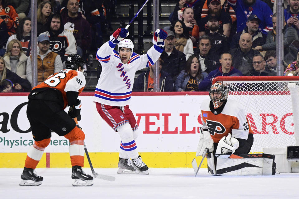 New York Rangers' Erik Gustafsson, center, reacts after a goal scored by Alexis Lafreniere past Philadelphia Flyers goaltender Samuel Ersson (33) during the second period of an NHL hockey game, Saturday, Feb. 24, 2024, in Philadelphia. (AP Photo/Derik Hamilton)