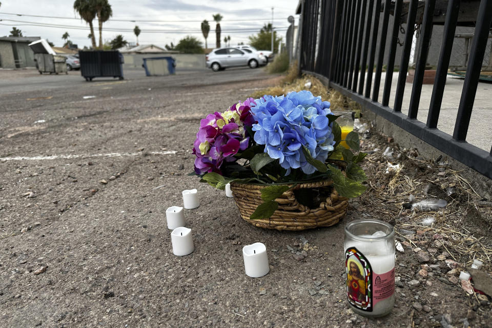 A small memorial is placed in an alleyway near Rancho High School in eastern Las Vegas on Wednesday, Nov. 15, 2023, the day after authorities announced the arrests of eight students on suspicion of murder in the beating of a classmate. Police said the fight happened two weeks earlier after classes ended for the day and left a 17-year-old boy dead. (AP Photo/Rio Yamat)