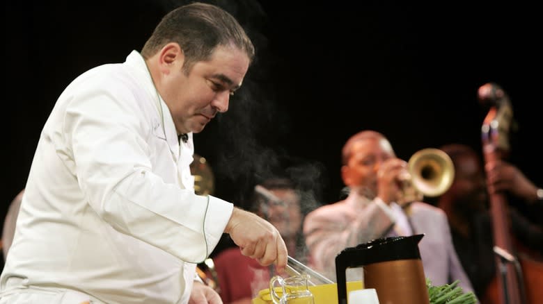 Emeril Lagasse cooking next to jazz band