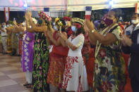 French Polynesians dressed in traditional clothes applause France's President Emmanuel Macron during his speech in Tahiti, French Polynesia in the Pacific Ocean, Tuesday, 27, 2021.President Emmanuel Macron reasserted France's presence in the Pacific on a visit to French Polynesia aimed in part at countering growing Chinese dominance in the region. (AP Photo/Esther Cuneo)