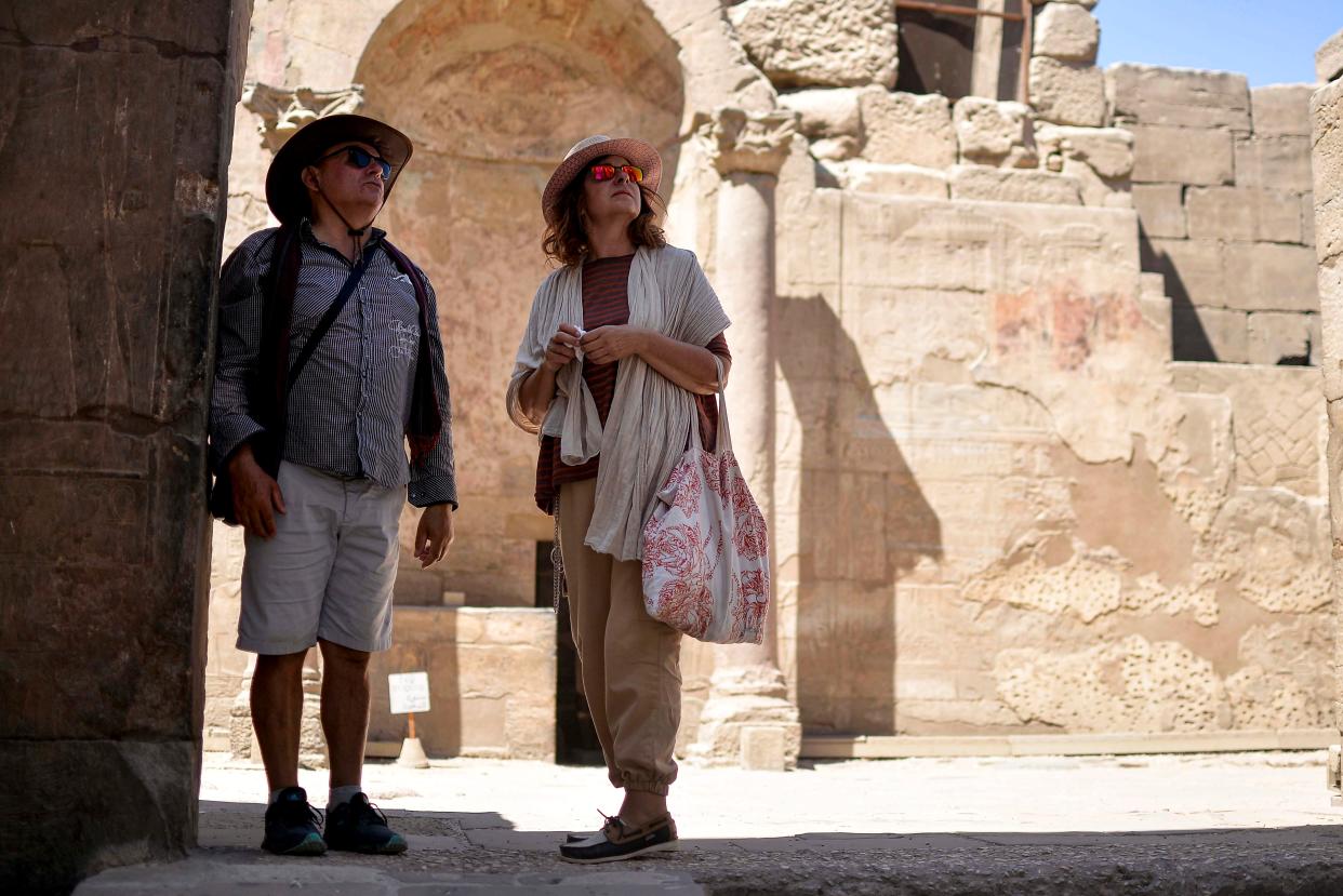 Tourists look as they visit the ancient Temple of Luxor in Egypt's southern city of Luxor on July 1, 2020.